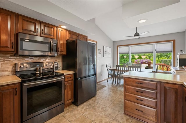 3893 Windsor Ct, Hermitage, PA 16148 - kitchen with stainless steel appliances, lofted ceiling, light countertops, backsplash, and light tile patterned floors