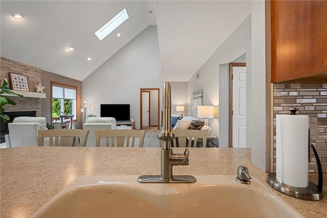3893 Windsor Ct, Hermitage, PA 16148 - kitchen with high vaulted ceiling, open floor plan, a fireplace, recessed lighting, and light countertops