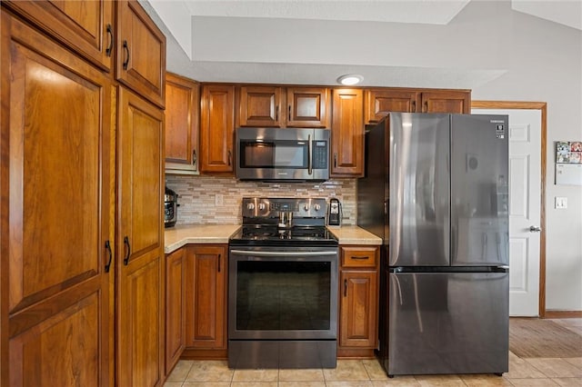 3893 Windsor Ct, Hermitage, PA 16148 - kitchen with stainless steel appliances, light countertops, and brown cabinetry