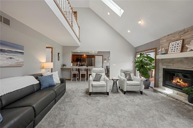 3893 Windsor Ct, Hermitage, PA 16148 - living room with high vaulted ceiling, light colored carpet, a skylight, a fireplace, and recessed lighting