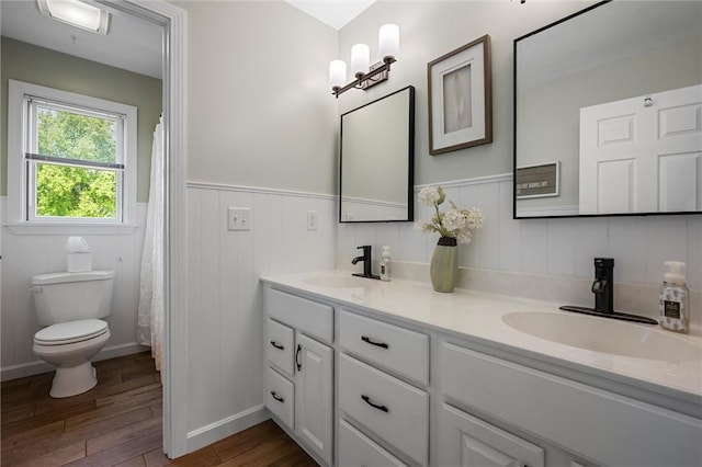 3893 Windsor Ct, Hermitage, PA 16148 - bathroom with toilet, wood finished floors, double vanity, a wainscoted wall, and curtained shower
