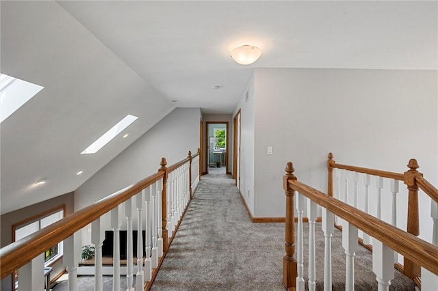 3893 Windsor Ct, Hermitage, PA 16148 - hallway featuring a skylight, lofted ceiling, carpet, an upstairs landing, and baseboards