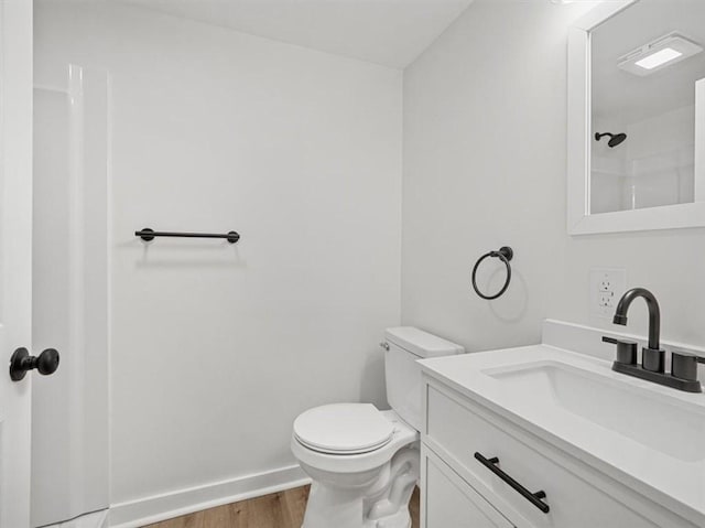 612 Blossom Dr, Baldwin Boro, PA 15236 - bathroom featuring wood finished floors, toilet, vanity, and baseboards
