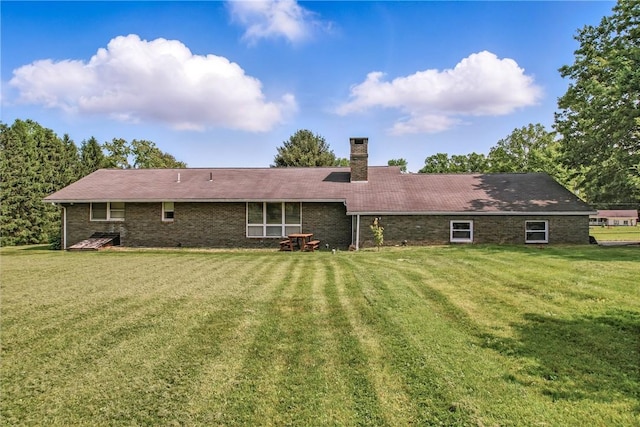 1011 S Lake Rd, Jefferson Twp Mer, PA 16137 - back of house featuring a lawn, a chimney, and brick siding