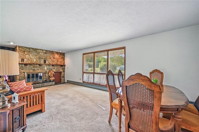 1011 S Lake Rd, Jefferson Twp Mer, PA 16137 - dining area with a baseboard heating unit, a fireplace, a textured ceiling, and carpet floors