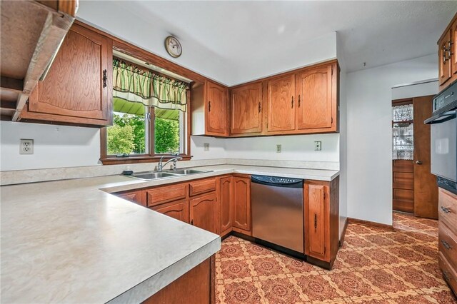 1011 S Lake Rd, Jefferson Twp Mer, PA 16137 - kitchen with stainless steel dishwasher, a sink, light countertops, and brown cabinetry