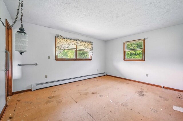 1011 S Lake Rd, Jefferson Twp Mer, PA 16137 - spare room featuring a baseboard heating unit, baseboards, and a textured ceiling