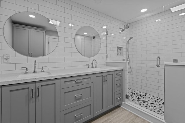 439 Center Grange Rd, Center Twp Bea, PA 15061 - full bathroom featuring a shower stall, double vanity, wood finished floors, backsplash, and tile walls