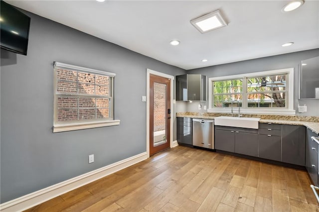 4825 Hatfield St, Lawrenceville, PA 15201 - kitchen featuring stainless steel dishwasher, a sink, gray cabinetry, light wood-type flooring, and light stone countertops