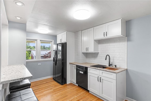 2693 Crosby Ave, Dormont, PA 15216 - kitchen featuring black refrigerator with ice dispenser, dishwasher, a sink, tasteful backsplash, and white cabinetry