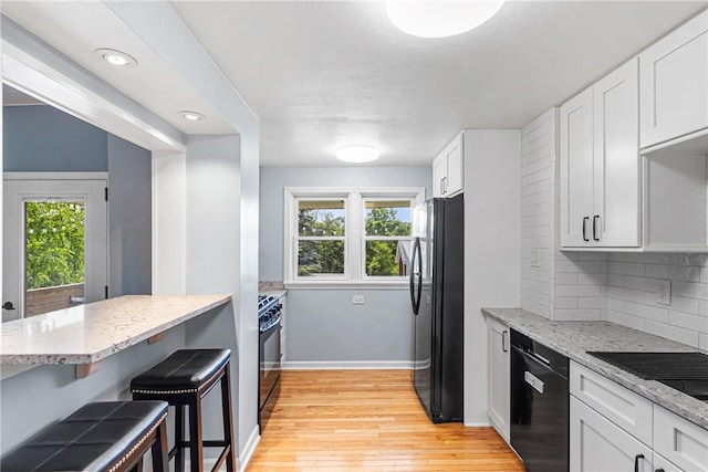 2693 Crosby Ave, Dormont, PA 15216 - kitchen featuring black appliances, healthy amount of natural light, backsplash, light stone counters, and recessed lighting