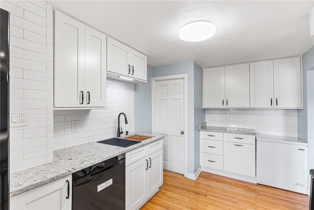 2693 Crosby Ave, Dormont, PA 15216 - kitchen with black dishwasher, a sink, decorative backsplash, and light wood finished floors