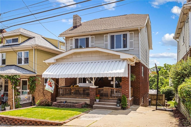 2693 Crosby Ave, Dormont, PA 15216 - view of front of house with a chimney, brick siding, a porch, a front yard, and roof with shingles