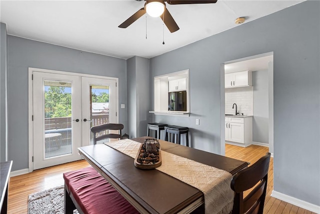 2693 Crosby Ave, Dormont, PA 15216 - dining space with french doors, light wood-style floors, a ceiling fan, and baseboards