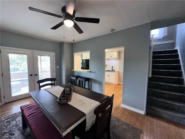 2693 Crosby Ave, Dormont, PA 15216 - dining space with stairs, french doors, light wood finished floors, a ceiling fan, and baseboards