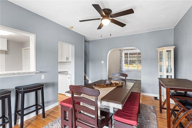 2693 Crosby Ave, Dormont, PA 15216 - dining area with arched walkways, light wood finished floors, stairway, ceiling fan, and baseboards