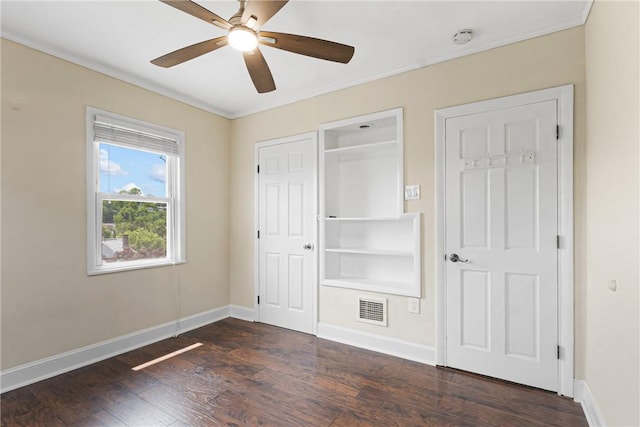 2693 Crosby Ave, Dormont, PA 15216 - unfurnished bedroom with dark wood-style flooring, crown molding, baseboards, a ceiling fan, and a closet
