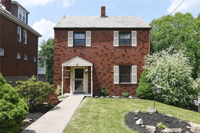 21 Leon Rd, Green Tree, PA 15220 - view of front of home with a chimney, a front yard, and brick siding