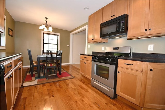 21 Leon Rd, Green Tree, PA 15220 - kitchen with black appliances, light wood-type flooring, a chandelier, dark countertops, and decorative light fixtures