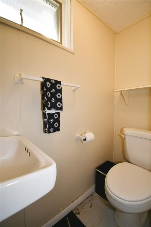 21 Leon Rd, Green Tree, PA 15220 - bathroom featuring marble look tiles, toilet, baseboards, and a sink