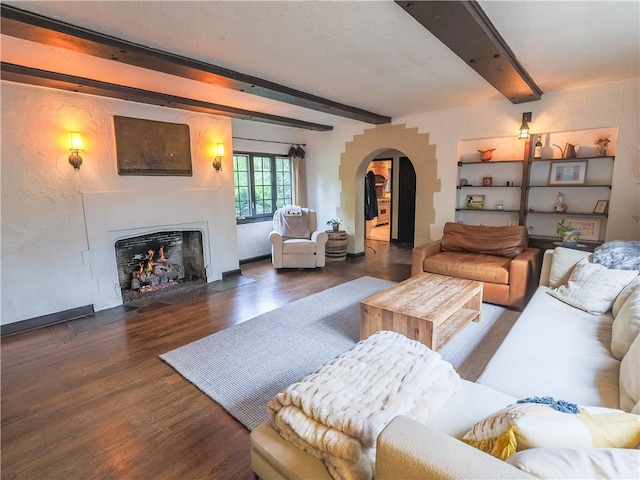464 Avon Dr, Mt Lebanon, PA 15228 - living room with arched walkways, beam ceiling, wood finished floors, and a fireplace with flush hearth