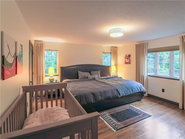464 Avon Dr, Mt Lebanon, PA 15228 - bedroom with wood finished floors, multiple windows, and baseboards
