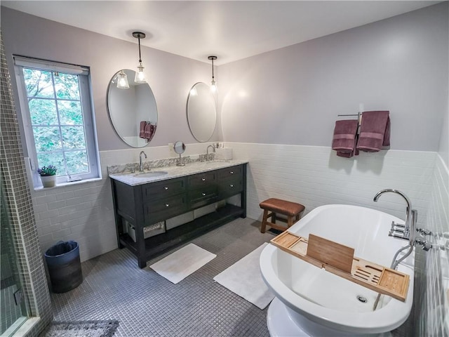 464 Avon Dr, Mt Lebanon, PA 15228 - full bath featuring tile walls, double vanity, wainscoting, a freestanding bath, and tile patterned flooring