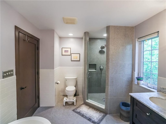 464 Avon Dr, Mt Lebanon, PA 15228 - bathroom featuring tile walls, toilet, a shower stall, vanity, and wainscoting