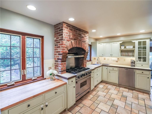 464 Avon Dr, Mt Lebanon, PA 15228 - kitchen featuring appliances with stainless steel finishes, open shelves, backsplash, a sink, and butcher block counters