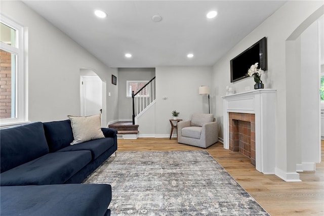1416 Swantek St, Sheraden, PA 15204 - living room with arched walkways, light wood-style floors, stairs, recessed lighting, and a fireplace