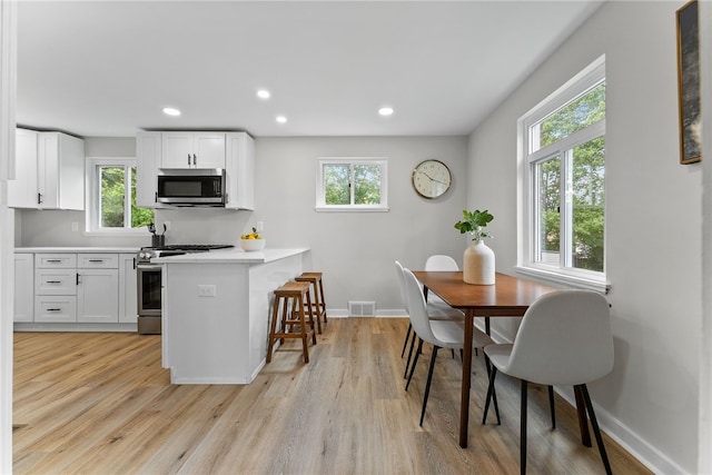 1416 Swantek St, Sheraden, PA 15204 - kitchen with stainless steel appliances, plenty of natural light, light wood finished floors, and recessed lighting