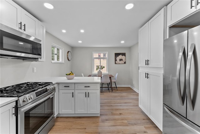 1416 Swantek St, Sheraden, PA 15204 - kitchen with appliances with stainless steel finishes, healthy amount of natural light, a peninsula, recessed lighting, and white cabinetry