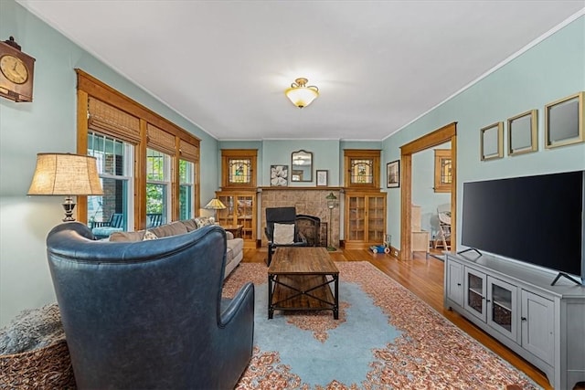 2352 Beaufort Ave, Brookline, PA 15226 - living room featuring wood finished floors, a tiled fireplace, and crown molding
