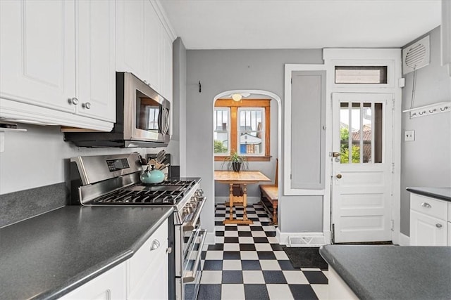 2352 Beaufort Ave, Brookline, PA 15226 - kitchen featuring stainless steel appliances, dark countertops, dark floors, white cabinetry, and baseboards