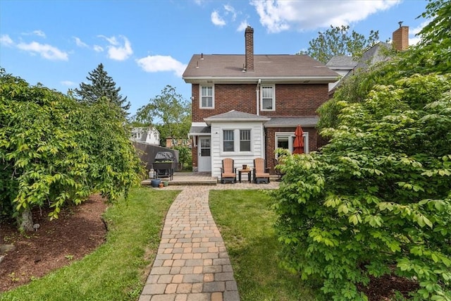 2352 Beaufort Ave, Brookline, PA 15226 - back of house featuring a yard, a chimney, brick siding, and a patio area