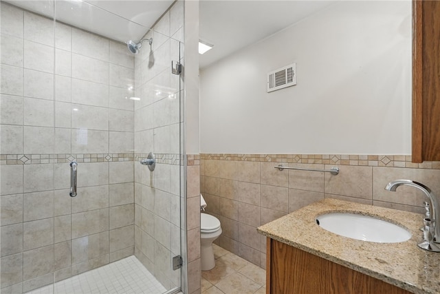 1450 Mohican Dr, Mt Lebanon, PA 15228 - bathroom featuring a shower stall, vanity, toilet, tile walls, and tile patterned flooring