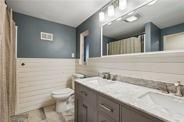 1450 Mohican Dr, Mt Lebanon, PA 15228 - bathroom featuring double vanity, marble finish floors, toilet, wainscoting, and a shower with shower curtain