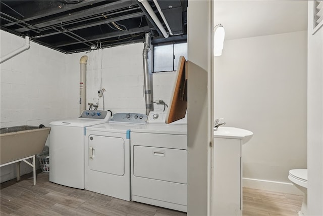 1450 Mohican Dr, Mt Lebanon, PA 15228 - washroom with washing machine and dryer, light wood finished floors, and baseboards