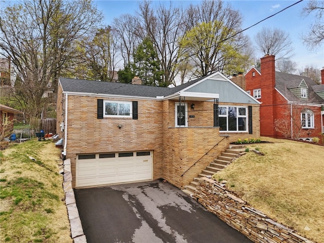 1450 Mohican Dr, Mt Lebanon, PA 15228 - view of front facade featuring asphalt driveway, a garage, a front yard, stairway, and brick siding