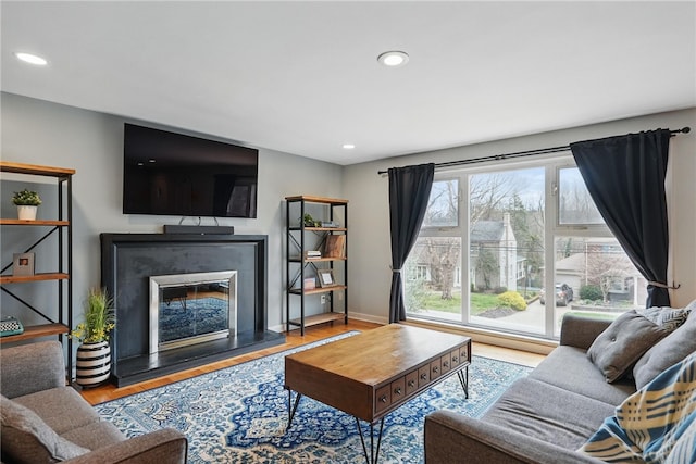 1450 Mohican Dr, Mt Lebanon, PA 15228 - living room with wood finished floors, recessed lighting, a glass covered fireplace, and baseboards