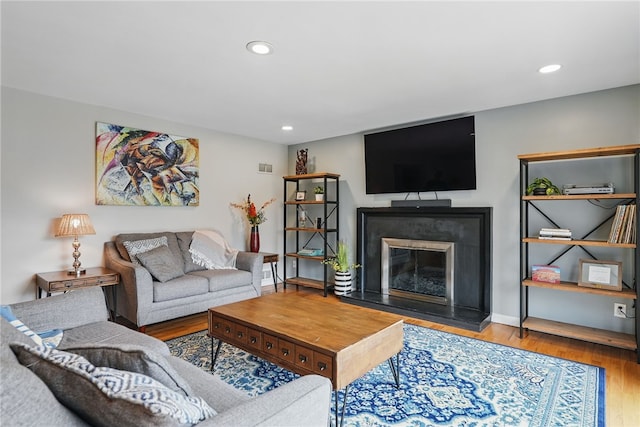 1450 Mohican Dr, Mt Lebanon, PA 15228 - living room with a glass covered fireplace, wood finished floors, recessed lighting, and baseboards