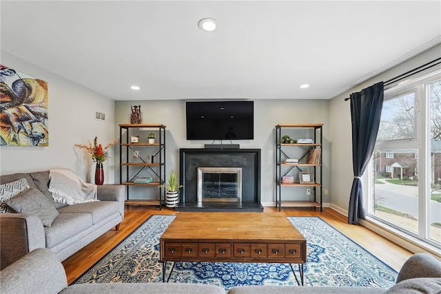 1450 Mohican Dr, Mt Lebanon, PA 15228 - living room with a glass covered fireplace, wood finished floors, recessed lighting, and baseboards