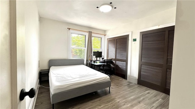 5427 Bartlett St, Squirrel Hill, PA 15217 - bedroom featuring two closets, an office area, wood finished floors, and baseboards