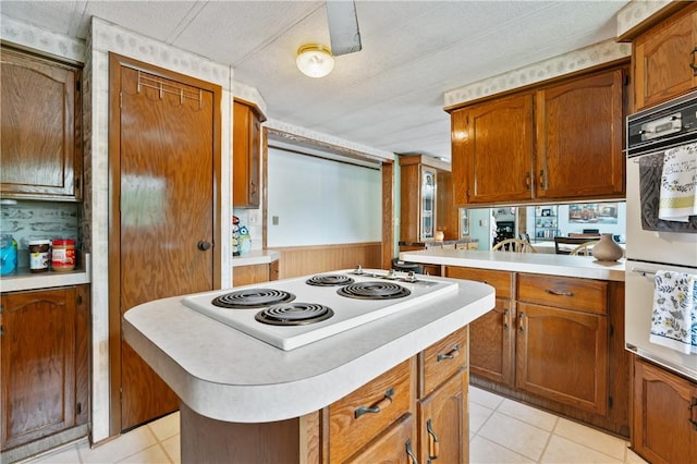 4041 Second St, Hempfield Twp Wml, PA 15642 - kitchen with white appliances, light countertops, light tile patterned flooring, and brown cabinetry
