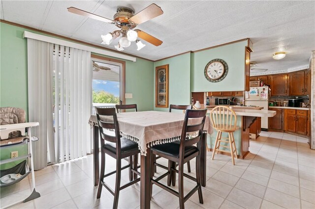4041 Second St, Hempfield Twp Wml, PA 15642 - dining room featuring a ceiling fan, light tile patterned flooring, and crown molding