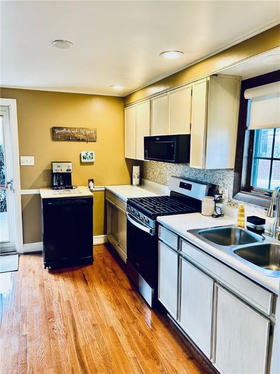 114 Tillotson Cir, Ross Twp, PA 15237 - kitchen featuring black microwave, stainless steel gas range oven, light countertops, decorative backsplash, and recessed lighting