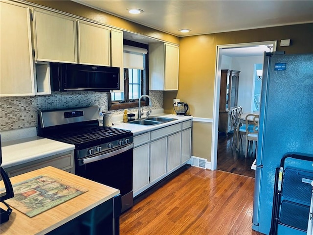 114 Tillotson Cir, Ross Twp, PA 15237 - kitchen with stainless steel gas range oven, freestanding refrigerator, a sink, light countertops, and black microwave