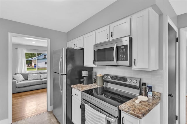 310 Hutter Ave, North Sewickley Twp, PA 16117 - kitchen with appliances with stainless steel finishes, stone countertops, white cabinetry, and decorative backsplash
