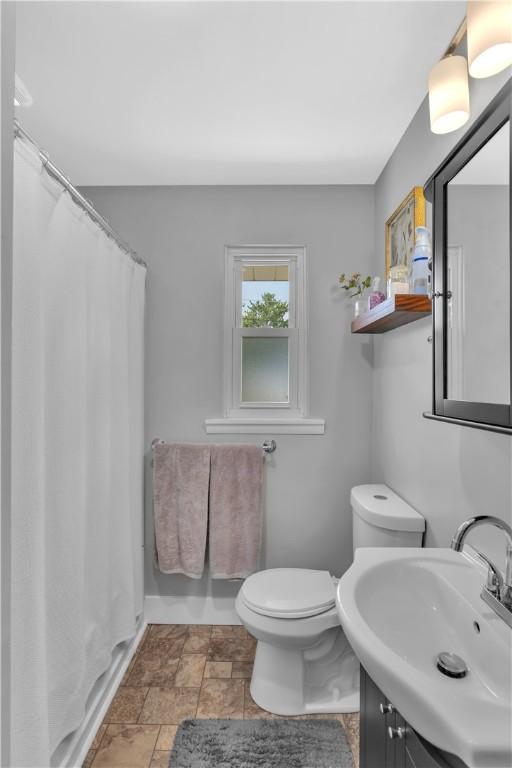 310 Hutter Ave, North Sewickley Twp, PA 16117 - full bathroom with stone finish flooring, toilet, vanity, and a shower with curtain