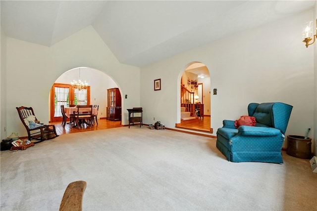 79 Mariacher Rd, Findley Twp, PA 16137 - living area featuring arched walkways, carpet, a chandelier, and high vaulted ceiling